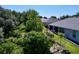 An elevated view of the backyard, screened-in enclosure, lush landscaping and patio set at 827 Princeton Dr, Clermont, FL 34711