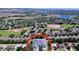 An aerial view of the house in a community with a lake and golf course at 827 Princeton Dr, Clermont, FL 34711