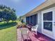 A patio set sits on brick pavers in a serene backyard with verdant green grass at 827 Princeton Dr, Clermont, FL 34711