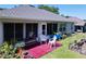 An eye-level view of a patio set, along with lush landscaping and a screened-in enclosure at 827 Princeton Dr, Clermont, FL 34711