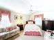 Bright bedroom featuring a comfortable sofa, ceiling fan, and natural light at 827 Princeton Dr, Clermont, FL 34711