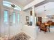 Light filled foyer featuring an ornate front door, adjacent to the dining room with a dining table and chairs at 827 Princeton Dr, Clermont, FL 34711