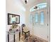 A welcoming foyer featuring a decorative rug, glass table, and ornate front door with transom window at 827 Princeton Dr, Clermont, FL 34711