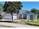 Lovely single-story home with a well-manicured lawn and landscaping including flowering plants and a Magnolia tree at 827 Princeton Dr, Clermont, FL 34711