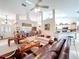 Open-concept living room with a partial view of the kitchen and dining area, featuring a sofa and upholstered chairs at 827 Princeton Dr, Clermont, FL 34711