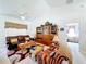 Comfortable living room with high ceilings, sofa, upholstered chairs, and a ceiling fan for year round comfort at 827 Princeton Dr, Clermont, FL 34711