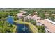 Aerial view of condo community nestled among lush landscaping and a beautiful lake with fountain at 8296 Portofino Dr # 405, Davenport, FL 33896