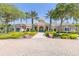 Beautiful clubhouse featuring a well-manicured lawn and palm tree lined entrance at 8296 Portofino Dr # 405, Davenport, FL 33896