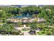 Aerial shot of a community clubhouse with a lake view, pool, and circular drive at 8296 Portofino Dr # 405, Davenport, FL 33896