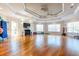 Bright exercise room features wood floors, TV, large windows, and fitness equipment at 8296 Portofino Dr # 405, Davenport, FL 33896