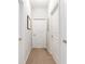 Bright hallway featuring neutral carpet and classic white doors at 8296 Portofino Dr # 405, Davenport, FL 33896