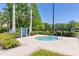 Relaxing community hot tub surrounded by manicured landscaping and spa rules sign at 8296 Portofino Dr # 405, Davenport, FL 33896