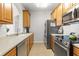 Well-lit kitchen features stainless steel appliances and light countertops at 8296 Portofino Dr # 405, Davenport, FL 33896