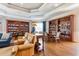 Relaxing lounge area with comfortable leather seating, bookshelves and wood flooring at 8296 Portofino Dr # 405, Davenport, FL 33896