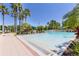 Large community pool with clear blue water and lush landscaping, perfect for relaxation at 8296 Portofino Dr # 405, Davenport, FL 33896