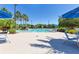 Resort-style swimming pool surrounded by palm trees and inviting lounge chairs at 8296 Portofino Dr # 405, Davenport, FL 33896