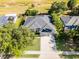 Aerial view of the home showing the roof, green lawns, and expansive driveway at 849 Shadowmoss Dr, Winter Garden, FL 34787