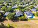 An aerial view of a home with solar panels, surrounded by trees, and a red boundary line marking the property at 849 Shadowmoss Dr, Winter Garden, FL 34787