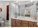 Well-lit bathroom featuring a vanity with a large mirror and a separate toilet area at 849 Shadowmoss Dr, Winter Garden, FL 34787