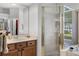 Bathroom featuring a corner shower with glass door, vanity and large mirror at 849 Shadowmoss Dr, Winter Garden, FL 34787