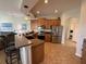 Bright kitchen boasts stainless steel appliances, wooden cabinets, granite countertops, and two stools at 849 Shadowmoss Dr, Winter Garden, FL 34787