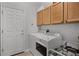Bright laundry room featuring modern appliances and ample cabinet space at 849 Shadowmoss Dr, Winter Garden, FL 34787