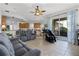 Open-concept living room with ample seating, ceiling fan, and sliding door to the outside at 849 Shadowmoss Dr, Winter Garden, FL 34787