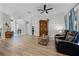 Spacious living area showcasing hardwood floors, comfortable seating, and an open floor plan at 849 Shadowmoss Dr, Winter Garden, FL 34787