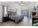 Serene main bedroom with tray ceiling, hardwood floors, ample natural light, and ensuite bath at 849 Shadowmoss Dr, Winter Garden, FL 34787