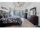 Spacious main bedroom features hardwood floors, tray ceiling, television, and ensuite bath at 849 Shadowmoss Dr, Winter Garden, FL 34787