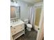 Bathroom featuring a stylish vanity, marble floors and a tub with shower at 855 Marion Dr, Mount Dora, FL 32757