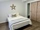 Bedroom featuring a comfortable bed and unique wooden barn door closet at 855 Marion Dr, Mount Dora, FL 32757