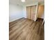 Bright bedroom features barn door closet and wood-look flooring at 855 Marion Dr, Mount Dora, FL 32757