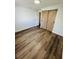 This bedroom has wood-look flooring and a barn door closet at 855 Marion Dr, Mount Dora, FL 32757