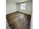 Empty bedroom featuring a hardwood floors, a window and neutral wall colors at 855 Marion Dr, Mount Dora, FL 32757