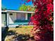 Lovely front exterior with a colorful flowering bush creating curb appeal to this cozy home at 855 Marion Dr, Mount Dora, FL 32757