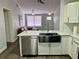 Modern kitchen featuring stainless steel dishwasher and open concept floor plan at 855 Marion Dr, Mount Dora, FL 32757