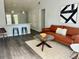Cozy living room featuring a leather sofa, area rug, and modern art at 855 Marion Dr, Mount Dora, FL 32757