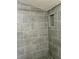 Updated walk-in shower with gray tiling and modern fixtures at 855 Marion Dr, Mount Dora, FL 32757