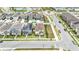 Stunning aerial view of modern homes in a well-planned community with lush landscaping and convenient roundabout access at 8573 Lamppost Ln, Orlando, FL 32832