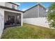 A spacious backyard features a screen enclosed lanai, lush grass, and a white privacy fence at 8573 Lamppost Ln, Orlando, FL 32832