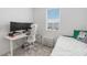 Bright bedroom features two monitors and a white desk, offering a comfortable and functional living space at 8573 Lamppost Ln, Orlando, FL 32832