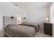 This bright bedroom features two beds, each with a stylish headboard, offering a relaxing and inviting space at 8573 Lamppost Ln, Orlando, FL 32832