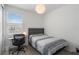 Well-lit bedroom with a work desk and a comfortable bed, perfect for relaxation and study at 8573 Lamppost Ln, Orlando, FL 32832