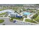Aerial view of a vibrant community pool area with a modern clubhouse and ample parking at 8573 Lamppost Ln, Orlando, FL 32832