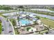 Amazing aerial of community pool, playground and picnic areas near beautiful lakes with palm trees and walking trails at 8573 Lamppost Ln, Orlando, FL 32832