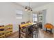 Cozy dining area with table, seating for four, and a view of the backyard at 8573 Lamppost Ln, Orlando, FL 32832