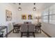 Modern dining room with seating for six, neutral colors, and unique lighting at 8573 Lamppost Ln, Orlando, FL 32832
