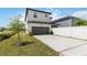 A well-maintained home featuring a two-car garage and a green lawn at 8573 Lamppost Ln, Orlando, FL 32832