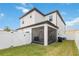 Exterior of the home, screened lanai with white privacy fence, and lush green grass at 8573 Lamppost Ln, Orlando, FL 32832